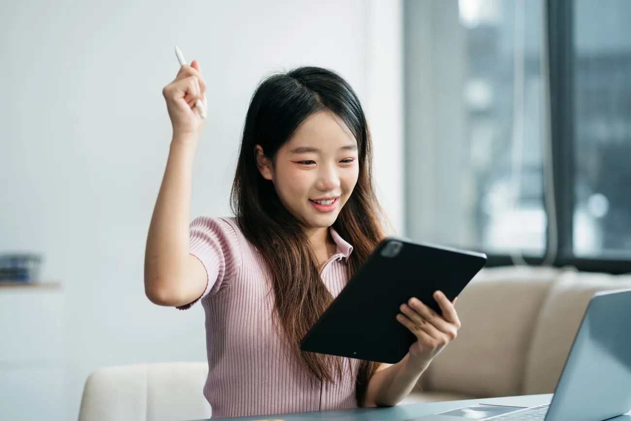 a woman holding a tablet and pen