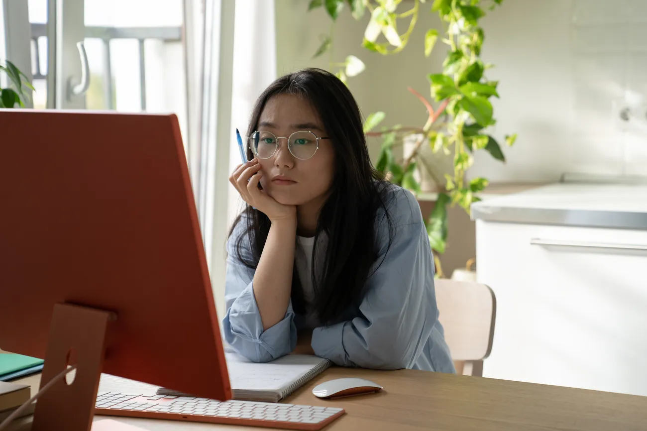 a woman sitting at a desk with a computer